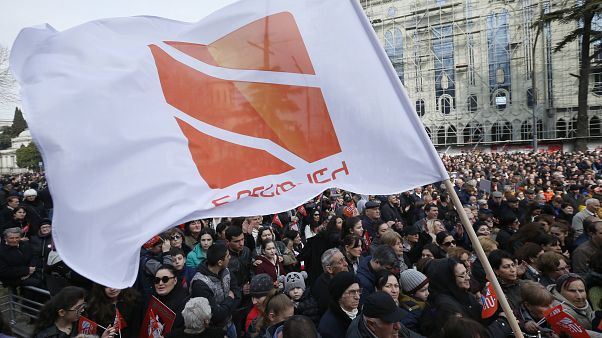 People hold flags with logo of Rustavi 2, Georgia's biggest independent television station, during rally.. People hold flags with logo of Rustavi 2, Georgia's biggest independent television station, during rally..