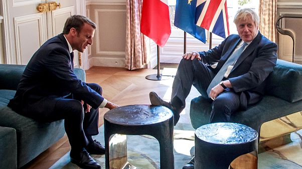İngiliz Başbakan Johnson, Macron'la görüşürken sehpaya ayak uzattı İngiliz Başbakan Johnson, Macron'la görüşürken sehpaya ayak uzattı