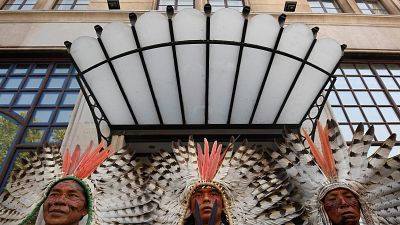 Indigenous protesters and environmental activists call to protect rainforest