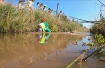 Competitors complete two lengths of a trench cut through a peat bog
