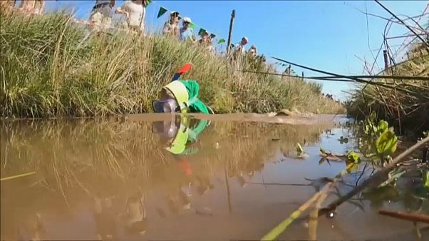 Competitors complete two lengths of a trench cut through a peat bog Competitors complete two lengths of a trench cut through a peat bog
