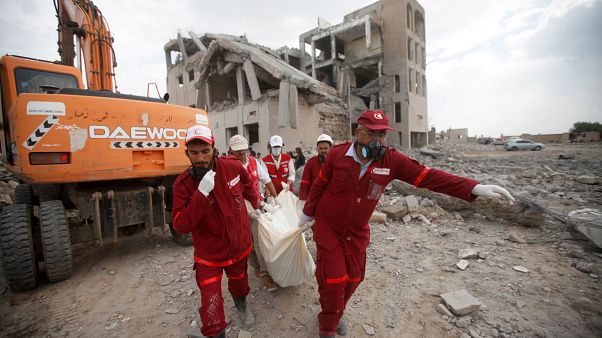 Red Crescent medics carry a body of the victim of Saudi-led airstrikes on a Houthi detention centre in Dhamar, Yemen, September 1, 2019. Red Crescent medics carry a body of the victim of Saudi-led airstrikes on a Houthi detention centre in Dhamar, Yemen, September 1, 2019.