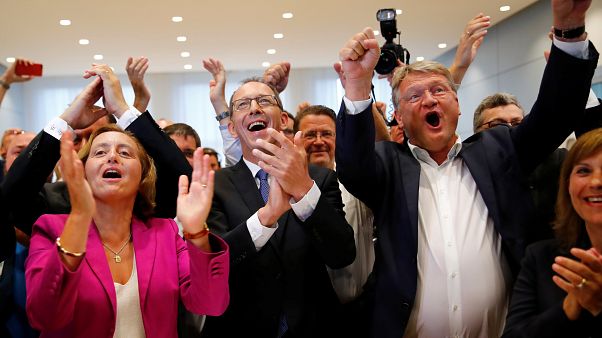 AfD candidates celebrate exit polls showing predicted gains in share of vote. AfD candidates celebrate exit polls showing predicted gains in share of vote.