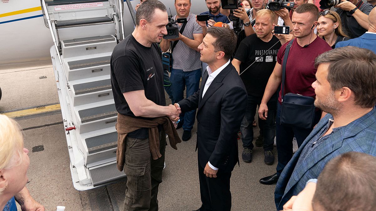 Ukrainian President Volodymyr Zelenskiy welcomes film director Oleg Sentsov, at Borispil International Airport, outside Kiev, Ukraine September 7, 2019. 