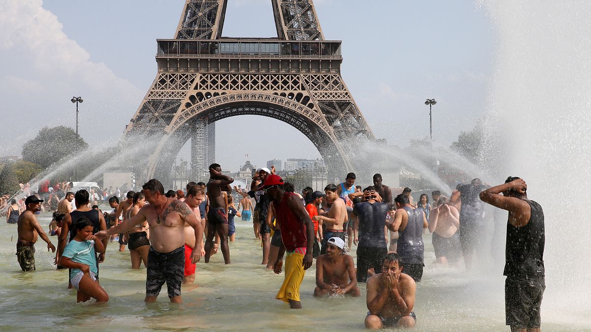 eople cool off in the Trocadero fountains across from the Eiffel Tower in Paris as a new heatwave broke temperature records in France, July 25, 2019.