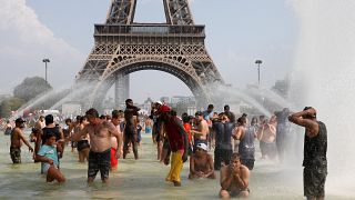 eople cool off in the Trocadero fountains across from the Eiffel Tower in Paris as a new heatwave broke temperature records in France, July 25, 2019.