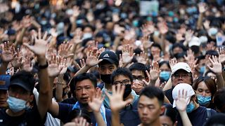 Protesters hold up their five fingers during a rally to the U.S. Consulate General in Hong Kong