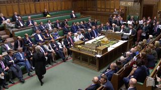 Opposition members of parliament hold signs around Speaker John Bercow after Britain’s parliament voted on whether to hold an early general election, in Parliament in London