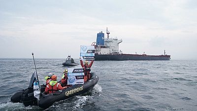 Greenpeace activists block a Mozambique cargo ship from unloading its load in Gdansk, Poland on September 9, 2019.