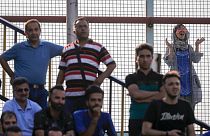 A female fan looks on as an Esteghlal FC game is underway