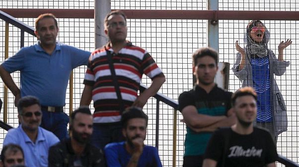 A female fan looks on as an Esteghlal FC game is underway A female fan looks on as an Esteghlal FC game is underway