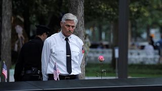 Man stands at reflecting pool ahead of ceremonies commemorating the 18th anniversary of the September 11, 2001 attacks at the 911 Memorial in lower Manhattan in New York