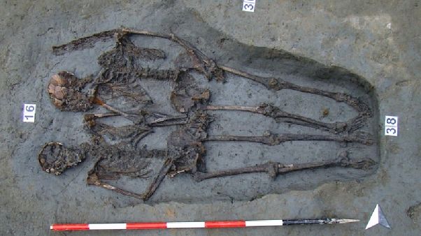The two men were buried side by side holding hands The two men were buried side by side holding hands
