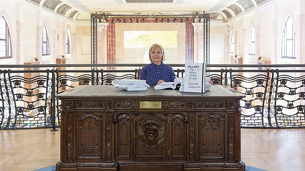 Clinton posed at a replica of the Oval Office's desk Clinton posed at a replica of the Oval Office's desk