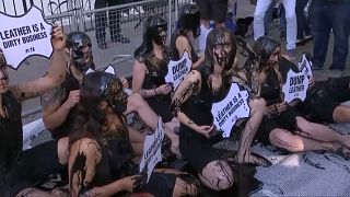 PETA activists doused themselves in black slime to highlight 'hazardous waste associated with the leather industry'