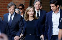 Actress Felicity Huffman leaves court with her husband William H. Macy (left)