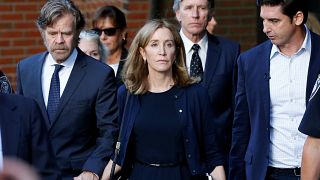 Actress Felicity Huffman leaves court with her husband William H. Macy (left)