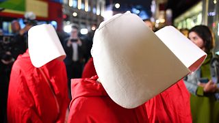 People dress up as characters from Margaret Atwood's Handmaid's Tale at the launch of its sequel