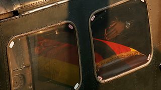 Robert Mugabe Junior's hands are seen near a casket carrying the remains of his father, Robert Mugabe.