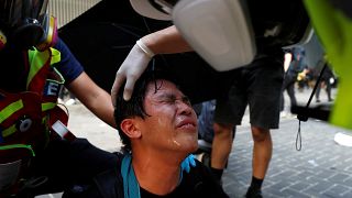 Anti-government cleans his eyes after tear gas was fired by the riot police during a demonstration near Central Government Complex in Hong Kong, China, September 15, 2019.