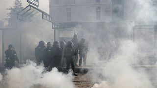 Tear gas floats in the air as protesters clash with French gendarme during a demonstration of the yellow vests movement in Nantes on September 14