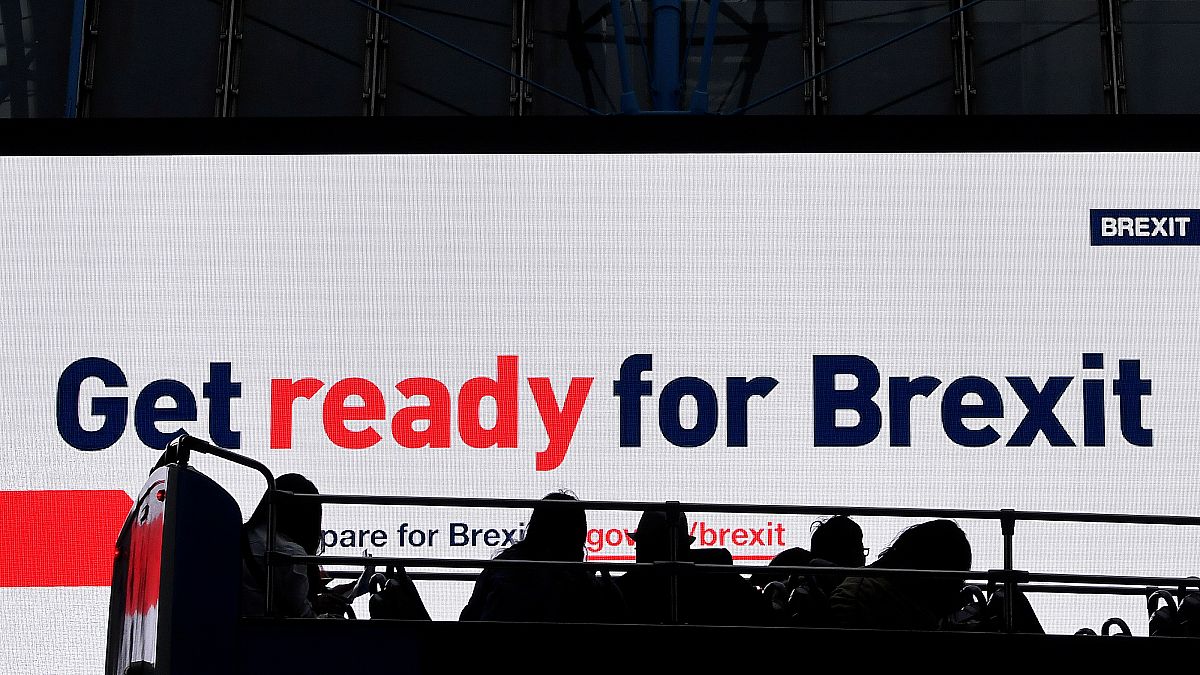 A bus passes an electronic billboard displaying a British government Brexit information awareness campaign advertisement in London, Britain