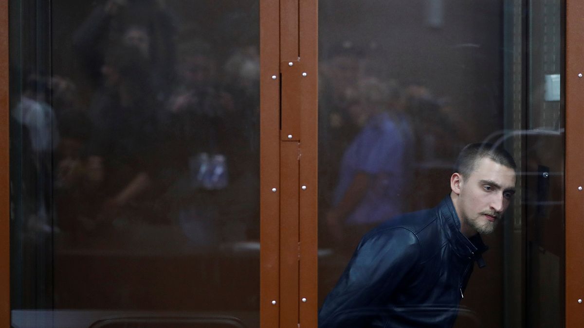 Pavel Ustinov, ammanettato, attende la sentenza. Sarà dura: 3 anni e mezzo di carcere. 
