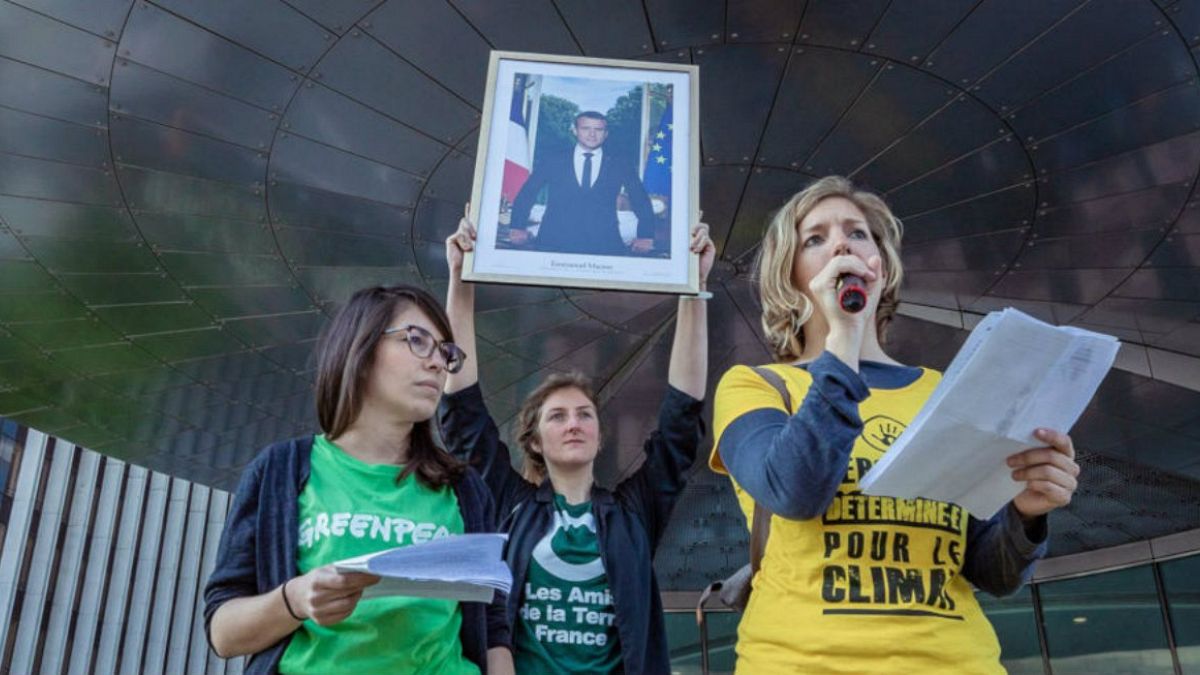Alternatiba activists with a portrait of French president Emmanuel Macron they've taken down, April 19, 2019.