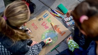 Young activists paint placards during the Fridays for Future global climate strike in Stockholm, Sweden, September 20, 2019.