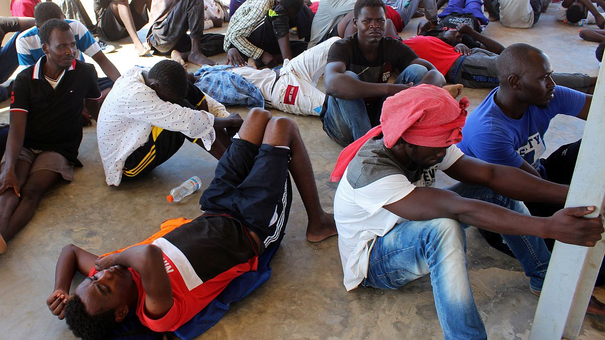Migrants are seen after being rescued by Libyan coast guard in Khoms in August