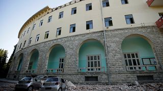 Destroyed cars stand next to a damaged building after an earthquake in Tirana, Albania, September 21, 2019.