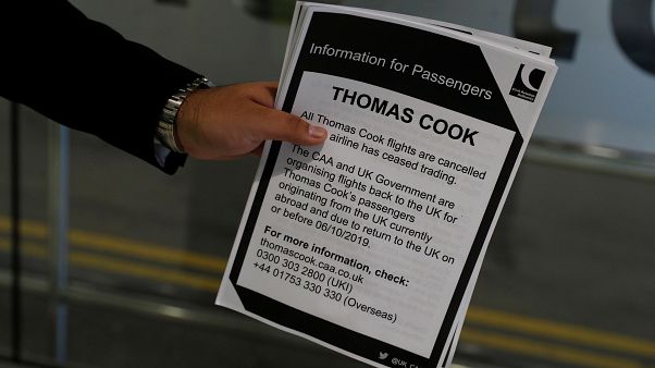 A man holds information on Thomas Cook flights at Manchester Airport, Manchester, Britain September 23, 2019. A man holds information on Thomas Cook flights at Manchester Airport, Manchester, Britain September 23, 2019.