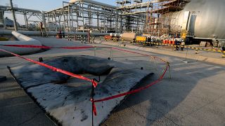 FILE PHOTO: A metal part of a damaged tank is seen at the damaged site of Saudi Aramco oil facility in Abqaiq, Saudi Arabia, September 20, 2019.