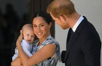 Britain's Prince Harry and his wife Meghan, Duchess of Sussex, holding their son Archie, meet Archbishop Desmond Tutu (not pictured)