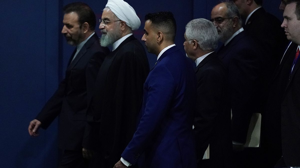 Iran's Hassan Rouhani walks with his entourage through the General Assembly Hall during the 74th session of the United Nations General Assembly at U.N. headquarters i