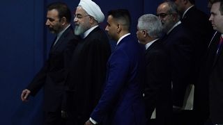 Iran's Hassan Rouhani walks with his entourage through the General Assembly Hall during the 74th session of the United Nations General Assembly at U.N. headquarters i