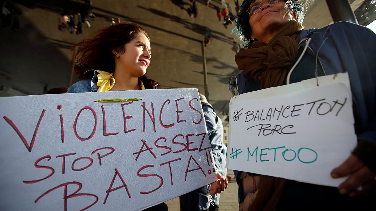 FILE PHOTO: Women hold placards reading, "Violence. Stop. Enough!" and #BalanceTonPorc - or 'expose your pig', during a gathering against gender-based  violence, France, 2017