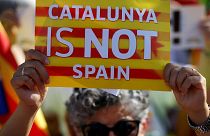 A protester holds a poster with the slogan "Catalunya is not Spain" in front of the European Parliament in Strasbourg