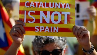 A protester holds a poster with the slogan "Catalunya is not Spain" in front of the European Parliament in Strasbourg