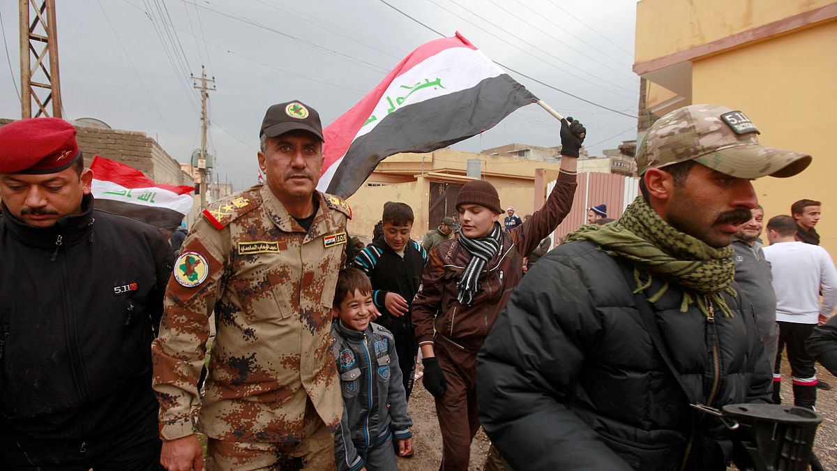 December 14, 2016 - Lieutenant General Abdelwahab al-Saadi (C) walks with children as they celebrate in Qadisiyah neighborhood north of Mosul, Iraq, December 14, 2016