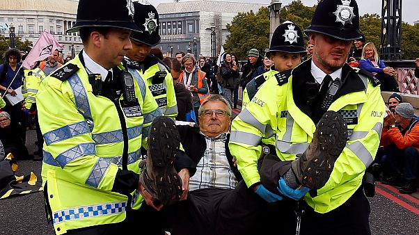 Police officers detain an activist at Lambeth Bridge during the Extinction Rebellion protest in London, Britain October 7, 2019. Police officers detain an activist at Lambeth Bridge during the Extinction Rebellion protest in London, Britain October 7, 2019.