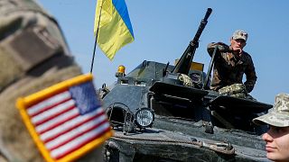 A military instructor of the U.S. Army is seen near Ukrainian servicemen during multinational drills "Rapid Trident 2019"