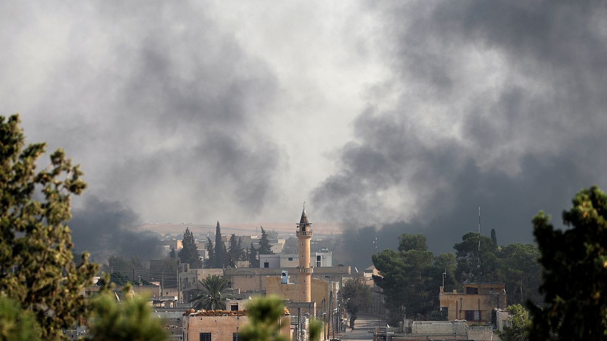 Smoke rises over the Syrian town of Ras al-Ain, as seen from the Turkish border town of Ceylanpinar, Sanliurfa province