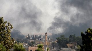 Smoke rises over the Syrian town of Ras al-Ain, as seen from the Turkish border town of Ceylanpinar, Sanliurfa province