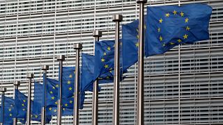 EU flags flutter in front of the European Commission headquarters in Brussels