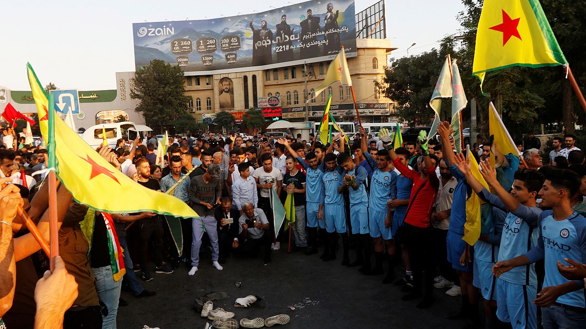 Kurds protest the Turkish offensive against Syria during a demonstration in Iraq
