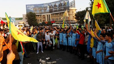 Kurds protest the Turkish offensive against Syria during a demonstration in Iraq