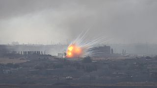 An explosion is seen over the Syrian town of Ras al-Ain as seen from the Turkish border town of Ceylanpinar, Sanliurfa province, Turkey, October 12, 2019. 