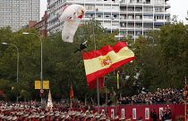 Parachutist left dangling during Spain's National Day parade