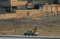 Turkish-backed Syrian rebels are seen in the Syrian border town of Tel Abyad, as seen from Akcakale, Turkey, October 13, 2019.